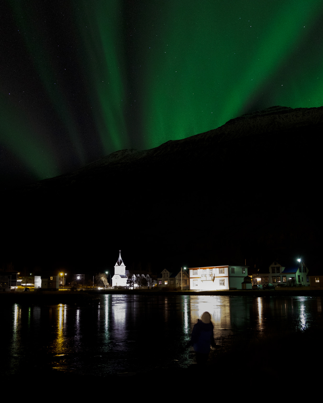 The northern lights over the Blue church in Seyðisfjörður